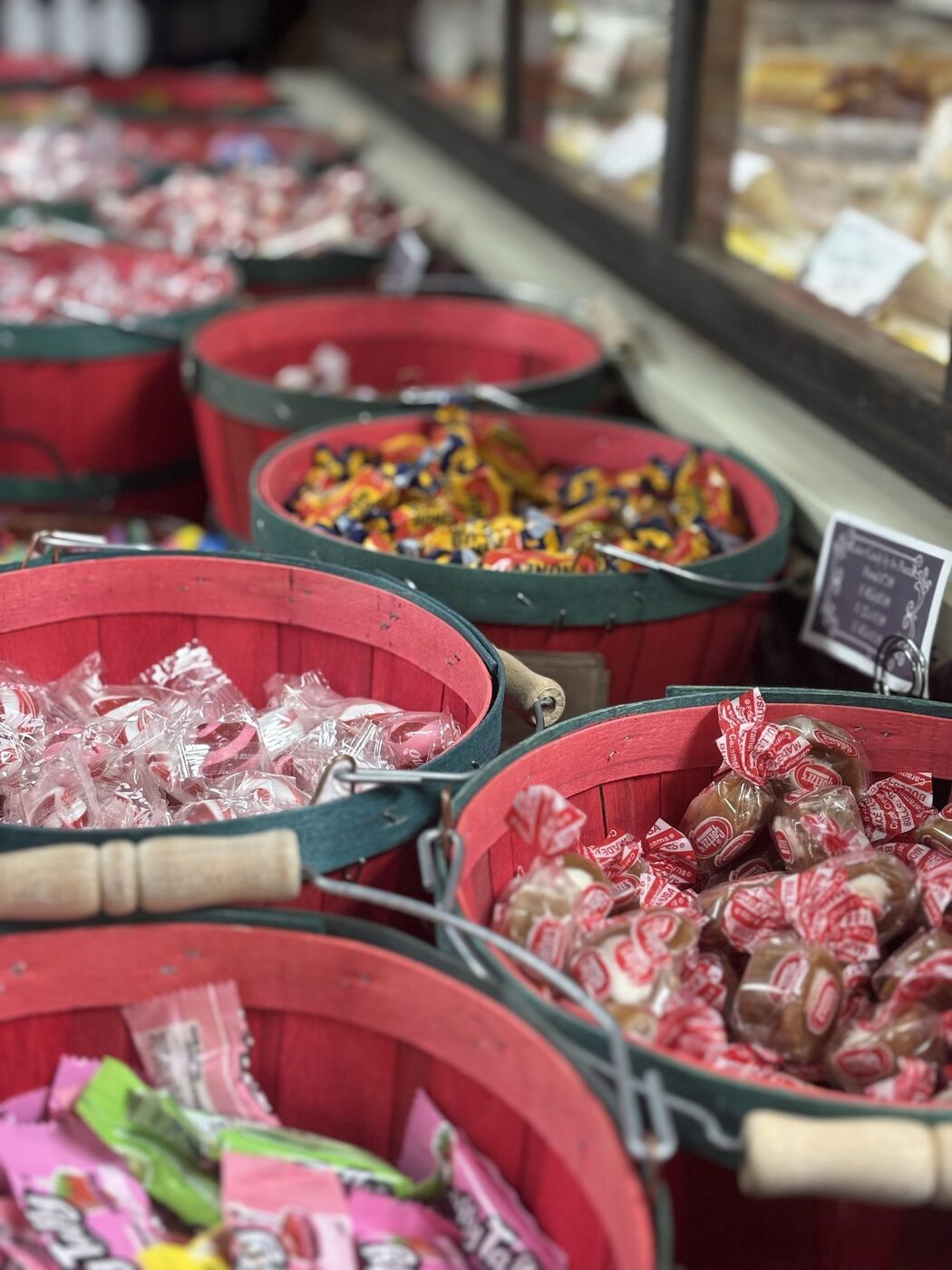 Red and green bushel baskets filled with classic wrapped candies